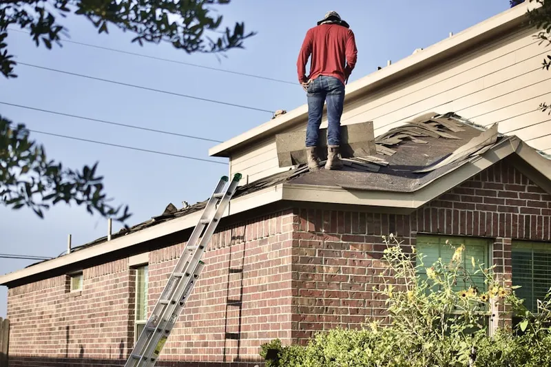 Professional roofer working on a residential roof in Hallandale Beach